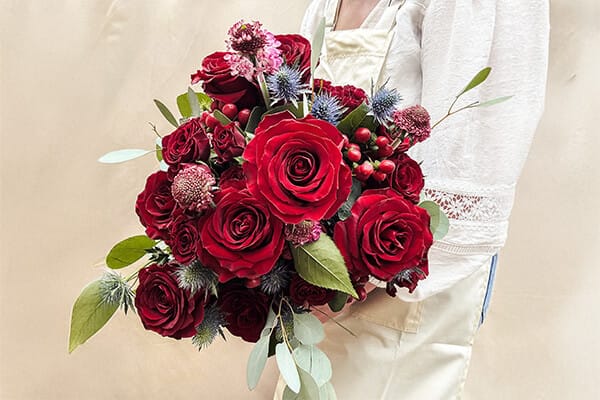 Devotion floral arrangement with rich, romantic flowers expressing deep affection