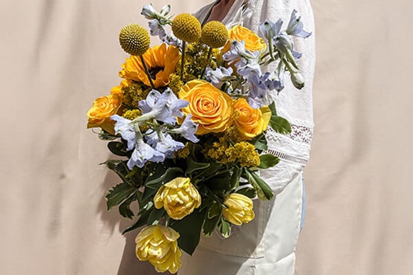 A bouquet of brightly colored yellow and blue flowers.